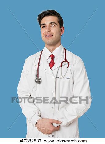 Stock Photo - Portrait of an Indian male healthcare professional standing with arms crossed. Fotosearch