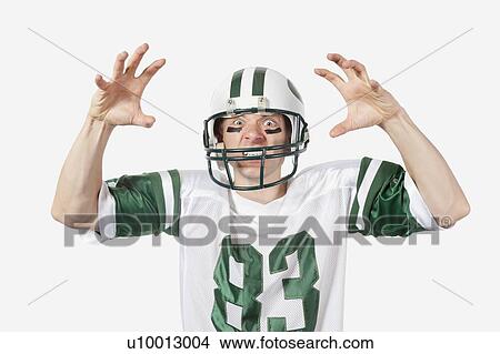 Portrait of angry young man in football uniform gesturing over gray background View Large Photo Image Picture - Portrait of angry young man in football uniform gesturing over gray background. Fotosearch