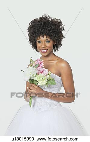 Portrait of beautiful African American bride holding bouquet over gray background View Large Photo Image Stock Image - Portrait of beautiful African American bride holding bouquet over gray background. Fotosearch