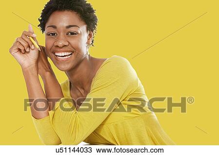 Portrait of Beautiful black african american woman wearing yellow top View Large Photo Image Stock Image - Portrait of Beautiful black african american woman wearing yellow top. Fotosearch
