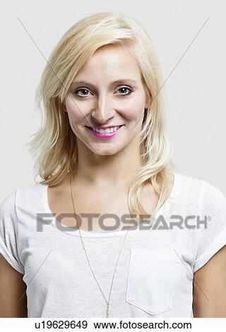Portrait of beautiful Caucasian woman smiling over gray background View Large Photo Image Stock Photo - Portrait of beautiful Caucasian woman smiling over gray background. Fotosearch