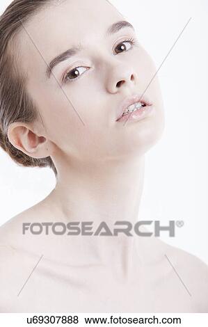 Portrait of beautiful young woman against white background View Large Photo Image Stock Photo - Portrait of beautiful young woman against white background. Fotosearch