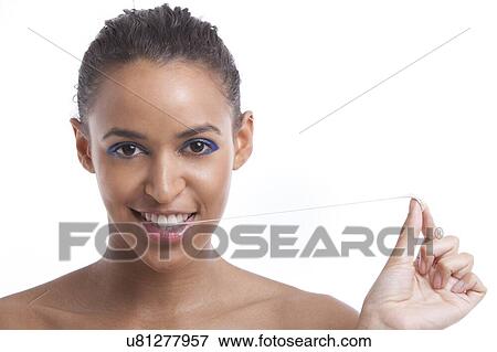 Portrait of beautiful young woman pulling chewing gum from her mouth against white background View Large Photo Image Stock Photo - Portrait of beautiful young woman pulling chewing gum from her mouth against white background. Fotosearch