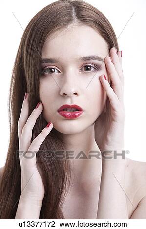 Portrait of beautiful young woman with red lips posing against white background View Large Photo Image Stock Image - Portrait of beautiful young woman with red lips posing against white background. Fotosearch