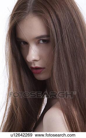 Portrait of beautiful young woman with long hair against white background View Large Photo Image Stock Photo - Portrait of beautiful young woman with long hair against white background. Fotosearch