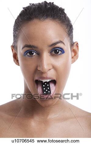 Portrait of beautiful young woman with domino on tongue against white background View Large Photo Image Stock Photography - Portrait of beautiful young woman with domino on tongue against white background. Fotosearch