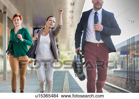 Picture - Portrait of business people running to catch the train in station. Fotosearch