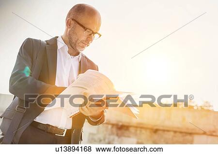 Portrait of businessman reading documents View Large Photo Image Stock Photo - Portrait of businessman reading documents. Fotosearch