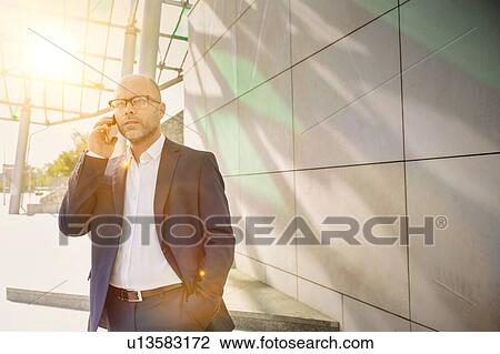 Portrait of businessman talking on smartphone View Large Photo Image Stock Image - Portrait of businessman talking on smartphone. Fotosearch