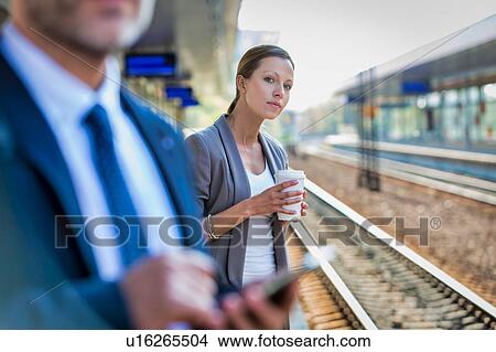 Portrait of businesswoman using smartphone while waiting for the train in station View Large Photo Image Picture - Portrait of businesswoman using smartphone while waiting for the train in station. Fotosearch