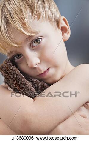 Portrait of Caucasian boy wiping his face with towel View Large Photo Image Stock Photograph - Portrait of Caucasian boy wiping his face with towel. Fotosearch