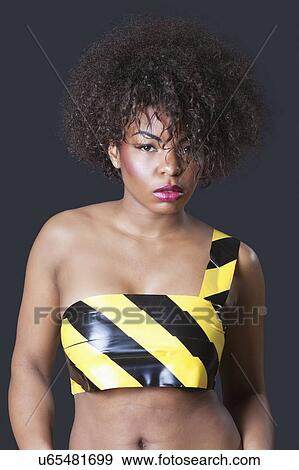 Portrait of caution tape on nude sensuous African American female View Large Photo Image Stock Photo - Portrait of caution tape on nude sensuous African American female. Fotosearch