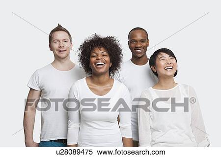Portrait of cheerful young multi-ethnic friends in casuals over white background View Large Photo Image Stock Photography - Portrait of cheerful young multi-ethnic friends in casuals over white background. Fotosearch