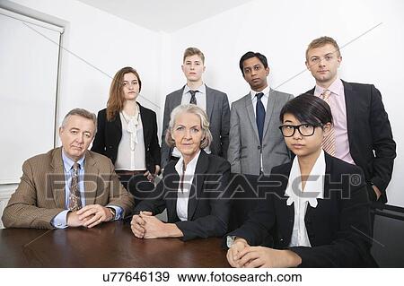 Portrait of confident multiethnic business group at desk in office View Large Photo Image Stock Photo - Portrait of confident multiethnic business group at desk in office. Fotosearch