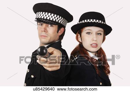 Portrait of confident police officers against gray background View Large Photo Image Stock Image - Portrait of confident police officers against gray background. Fotosearch