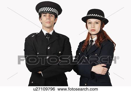 Stock Photograph - Portrait of confident police officers with arms crossed against white background. Fotosearch