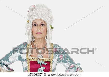 Stock Image - Portrait of confident senior queen over gray background. Fotosearch