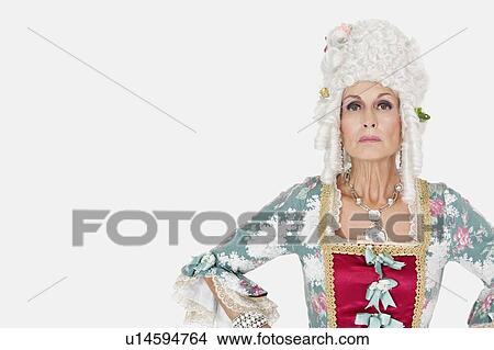 Picture - Portrait of confident senior queen against gray background. Fotosearch