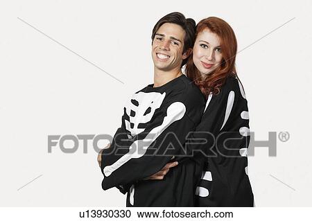 Portrait of couple in skeleton costume over gray background View Large Photo Image Stock Image - Portrait of couple in skeleton costume over gray background. Fotosearch