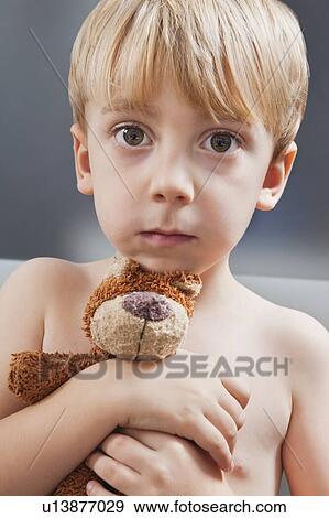 Stock Photo - Portrait of cute Caucasian boy with teddy bear. Fotosearch