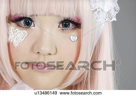 Portrait of cute woman dressed as a doll over gray background View Large Photo Image Stock Photo - Portrait of cute woman dressed as a doll over gray background. Fotosearch