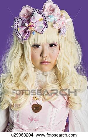Portrait of cute woman in doll costume over purple background View Large Photo Image Picture - Portrait of cute woman in doll costume over purple background. Fotosearch