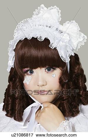 Portrait of cute woman in doll costume over gray background View Large Photo Image Stock Photo - Portrait of cute woman in doll costume over gray background. Fotosearch