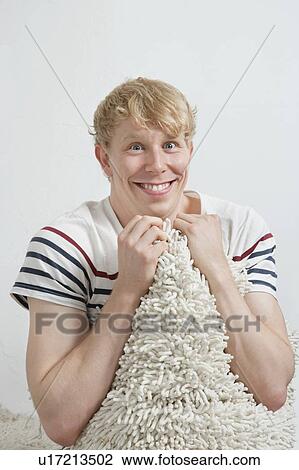 Portrait of excited young man holding fur blanket View Large Photo Image Stock Image - Portrait of excited young man holding fur blanket. Fotosearch
