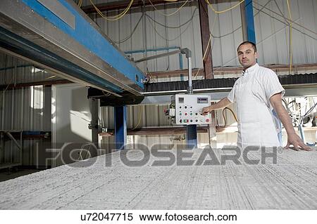 Portrait of factory worker operating machinery View Large Photo Image Stock Photography - Portrait of factory worker operating machinery. Fotosearch