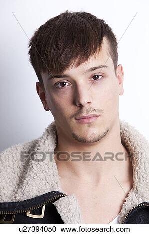 Stock Image - Portrait of handsome young man against white background. Fotosearch