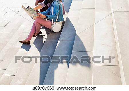 Portrait of handsome young man showing pictures on camera to his beautiful girlfriend while sitting against museum with lens flare in background View Large Photo Image Stock Image - Portrait of handsome young man showing pictures on camera to his beautiful girlfriend while sitting against museum with lens flare in background. Fotosearch