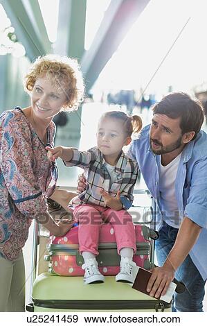 Portrait of happy family going on a holiday in airport View Large Photo Image Stock Photo - Portrait of happy family going on a holiday in airport. Fotosearch