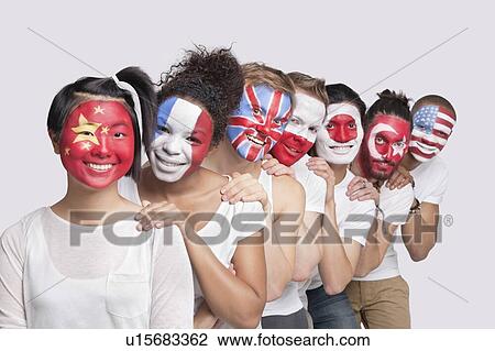 Stock Image - Portrait of happy Multi-ethnic group of friends with various national flags painted on their faces standing against white background. Fotosearch