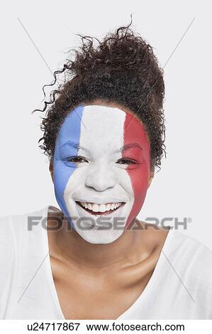Portrait of happy young African American woman with French flag painted on face against white background View Large Photo Image Stock Photo - Portrait of happy young African American woman with French flag painted on face against white background. Fotosearch