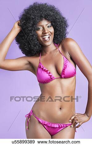Portrait of happy young woman in bikini posing over violet background View Large Photo Image Stock Photo - Portrait of happy young woman in bikini posing over violet background. Fotosearch
