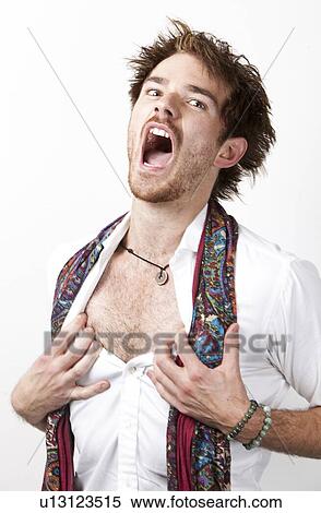Stock Photography - Portrait of humorous young man screaming against white background. Fotosearch