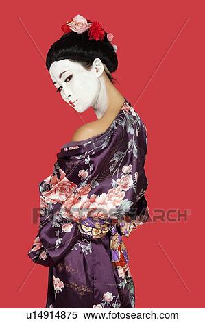 Portrait of Japanese woman in kimono standing over red background View Large Photo Image Stock Photography - Portrait of Japanese woman in kimono standing over red background. Fotosearch