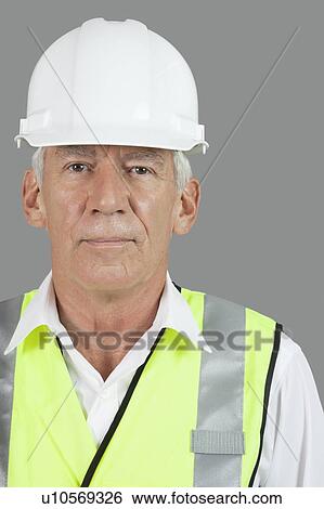 Portrait of male senior construction worker wearing hard hat over white background View Large Photo Image Stock Photograph - Portrait of male senior construction worker wearing hard hat over white background. Fotosearch