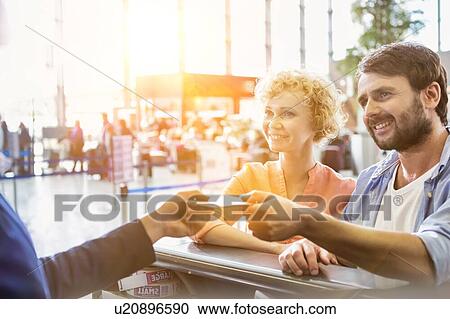 Portrait of man giving passport to passenger service agent to get his boarding pass in airport View Large Photo Image Stock Image - Portrait of man giving passport to passenger service agent to get his boarding pass in airport. Fotosearch