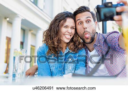 Portrait of man taking selfie with his beautiful girlfriend View Large Photo Image Stock Image - Portrait of man taking selfie with his beautiful girlfriend. Fotosearch