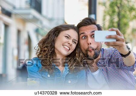 Portrait of man taking selfie with his beautiful girlfriend View Large Photo Image Stock Photo - Portrait of man taking selfie with his beautiful girlfriend. Fotosearch