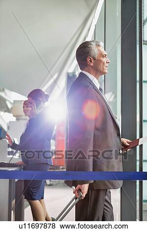 Portrait of Mature businessman boarding on the plane in airport View Large Photo Image Stock Photo - Portrait of Mature businessman boarding on the plane in airport. Fotosearch