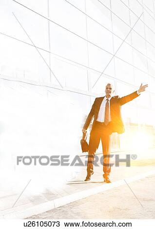 Portrait of mature businessman calling taxi in the airport View Large Photo Image Stock Image - Portrait of mature businessman calling taxi in the airport. Fotosearch