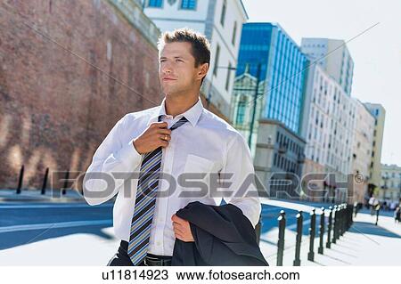 Portrait of mature businessman walking on pavement after work View Large Photo Image Stock Image - Portrait of mature businessman walking on pavement after work. Fotosearch
