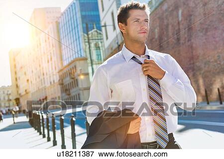 Portrait of mature businessman walking on pavement after work View Large Photo Image Stock Photo - Portrait of mature businessman walking on pavement after work. Fotosearch