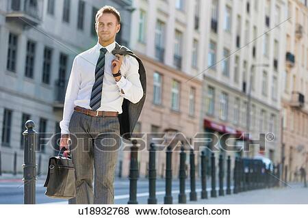 Portrait of mature businessman walking on pavement after work View Large Photo Image Stock Photo - Portrait of mature businessman walking on pavement after work. Fotosearch