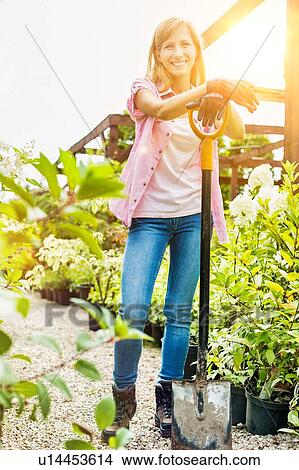 Portrait of mature female gardener holding shovel View Large Photo Image Picture - Portrait of mature female gardener holding shovel. Fotosearch