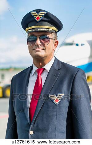 Portrait of mature pilot standing against airplane in airport View Large Photo Image Stock Photography - Portrait of mature pilot standing against airplane in airport. Fotosearch