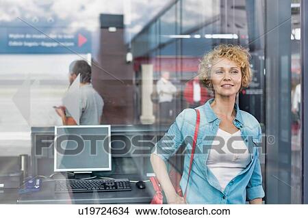 Portrait of mature woman boarding her flight in airport View Large Photo Image Picture - Portrait of mature woman boarding her flight in airport. Fotosearch