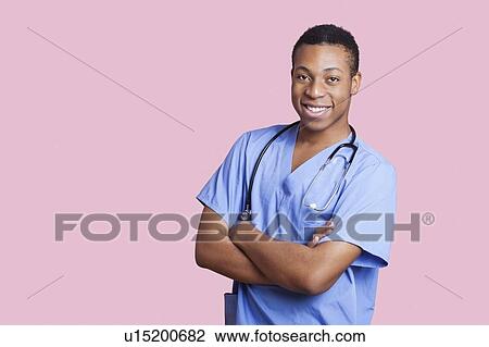 Portrait of mixed race male surgeon with arms crossed over pink background View Large Photo Image Stock Image - Portrait of mixed race male surgeon with arms crossed over pink background. Fotosearch